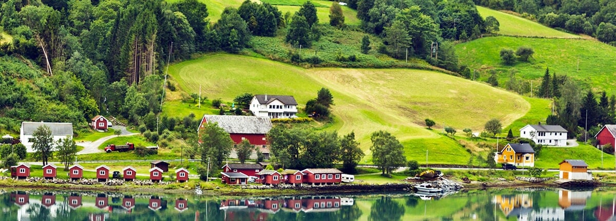 village along green hills in olden, norway