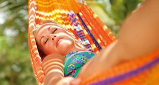 a woman resting on a hammock